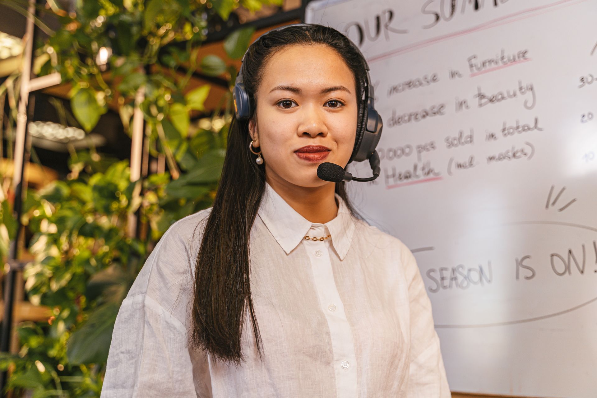 Friendly professional smiling on a video call from a sunlit modern workspace